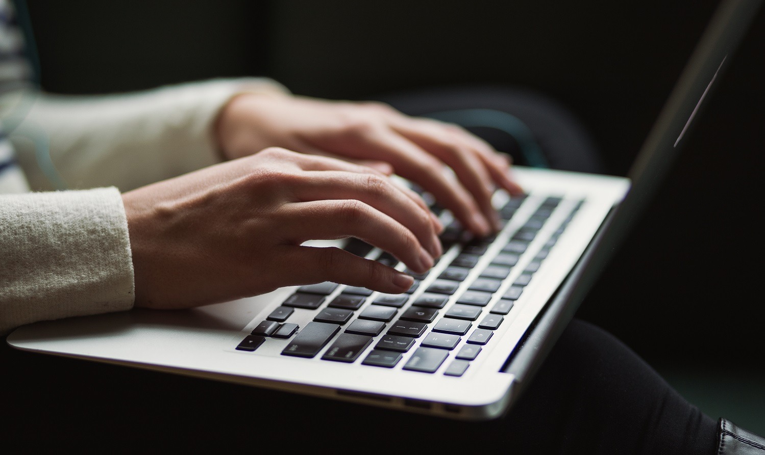 hands typing on a computer keyboard